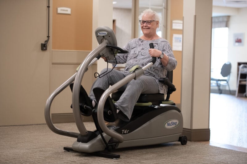 Woman exercising on machine