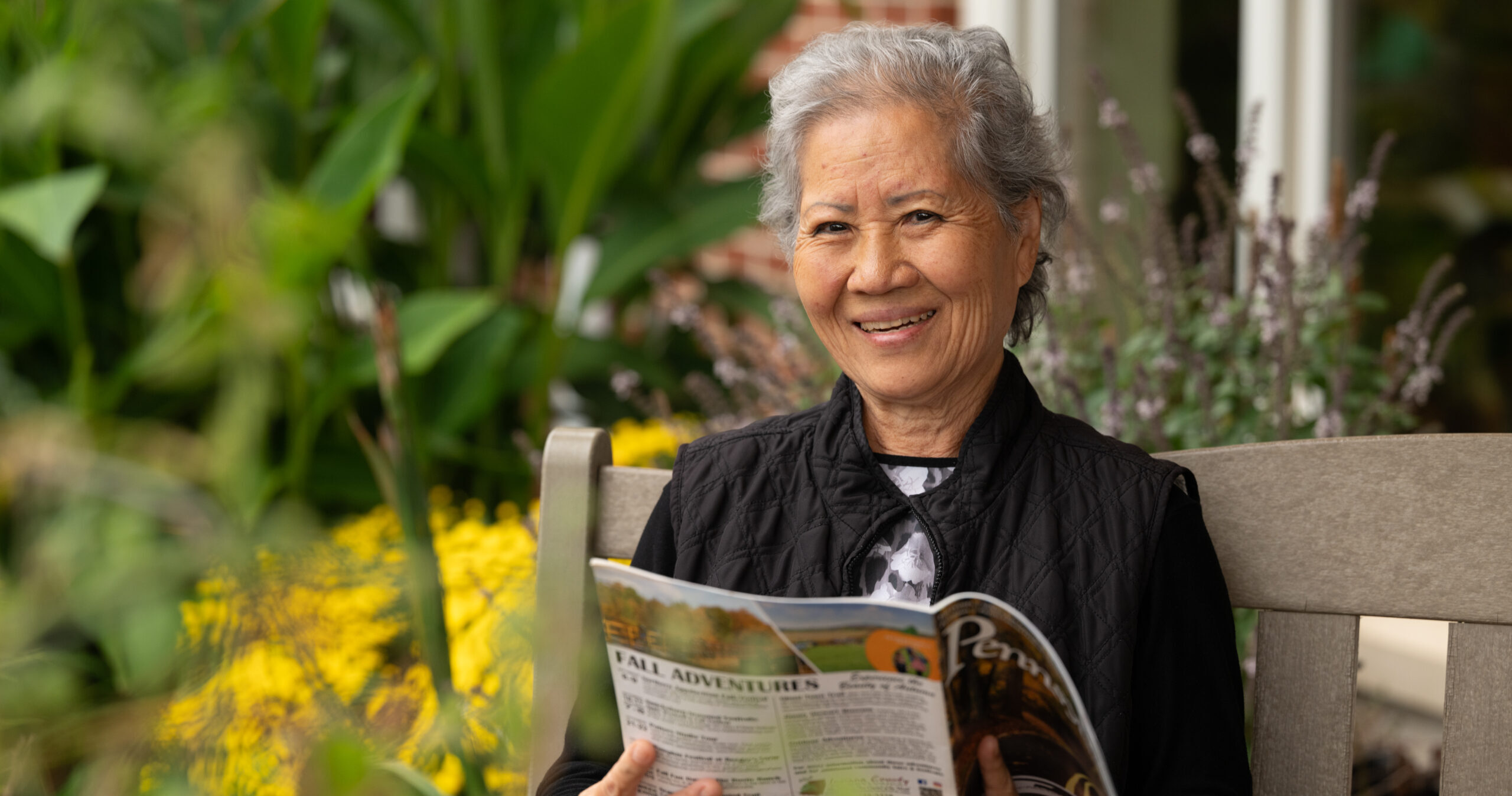 man reading a book in a garden